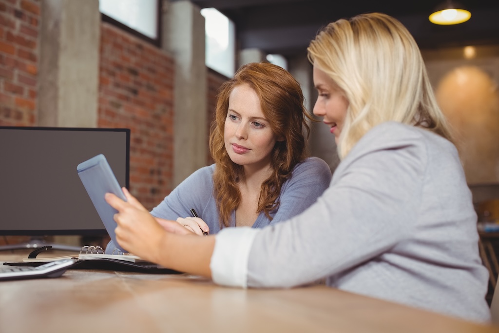 Beautiful businesswoman briefing colleague in creative office